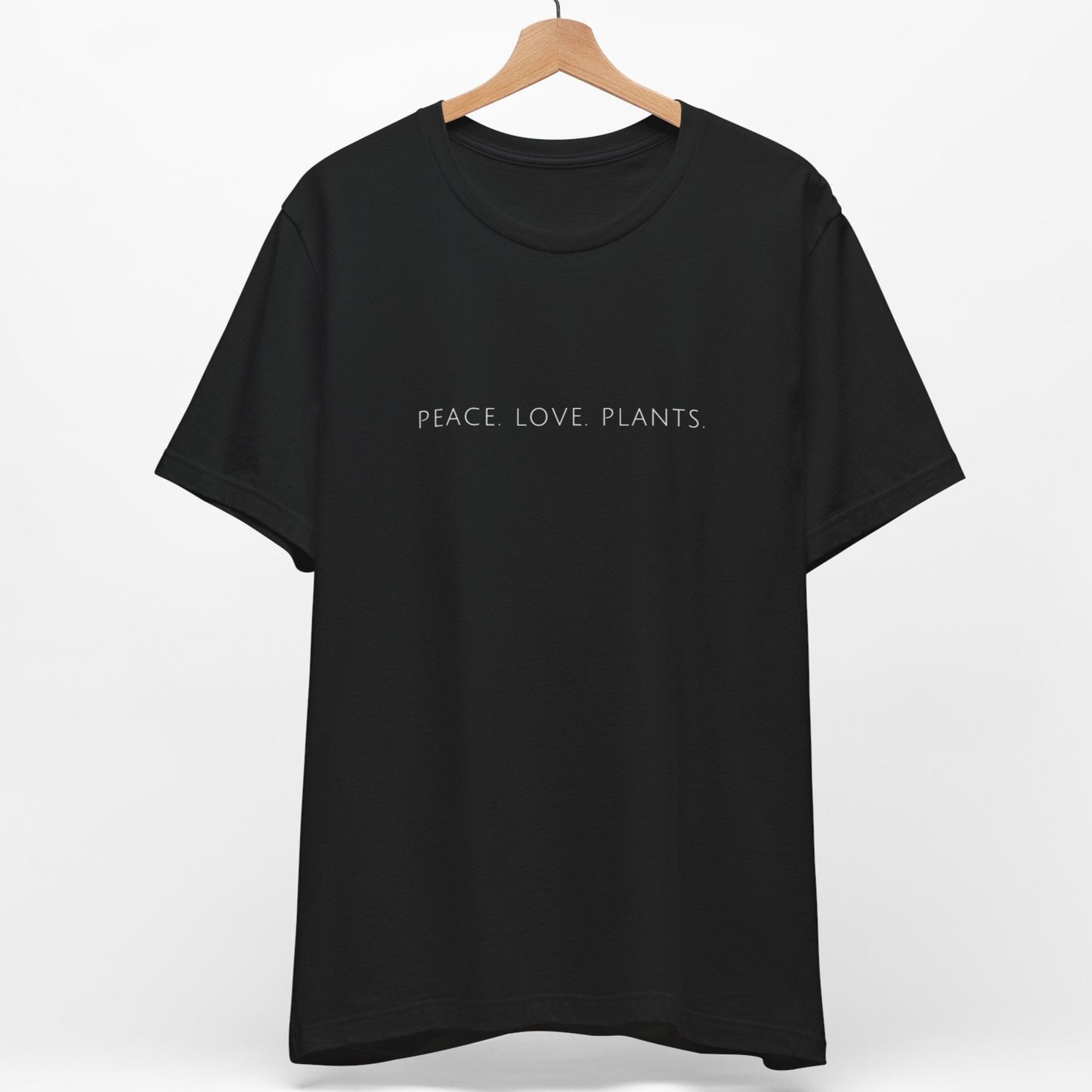Black vegan t-shirt with the slogan 'peace love plants' written in a minimalist font.