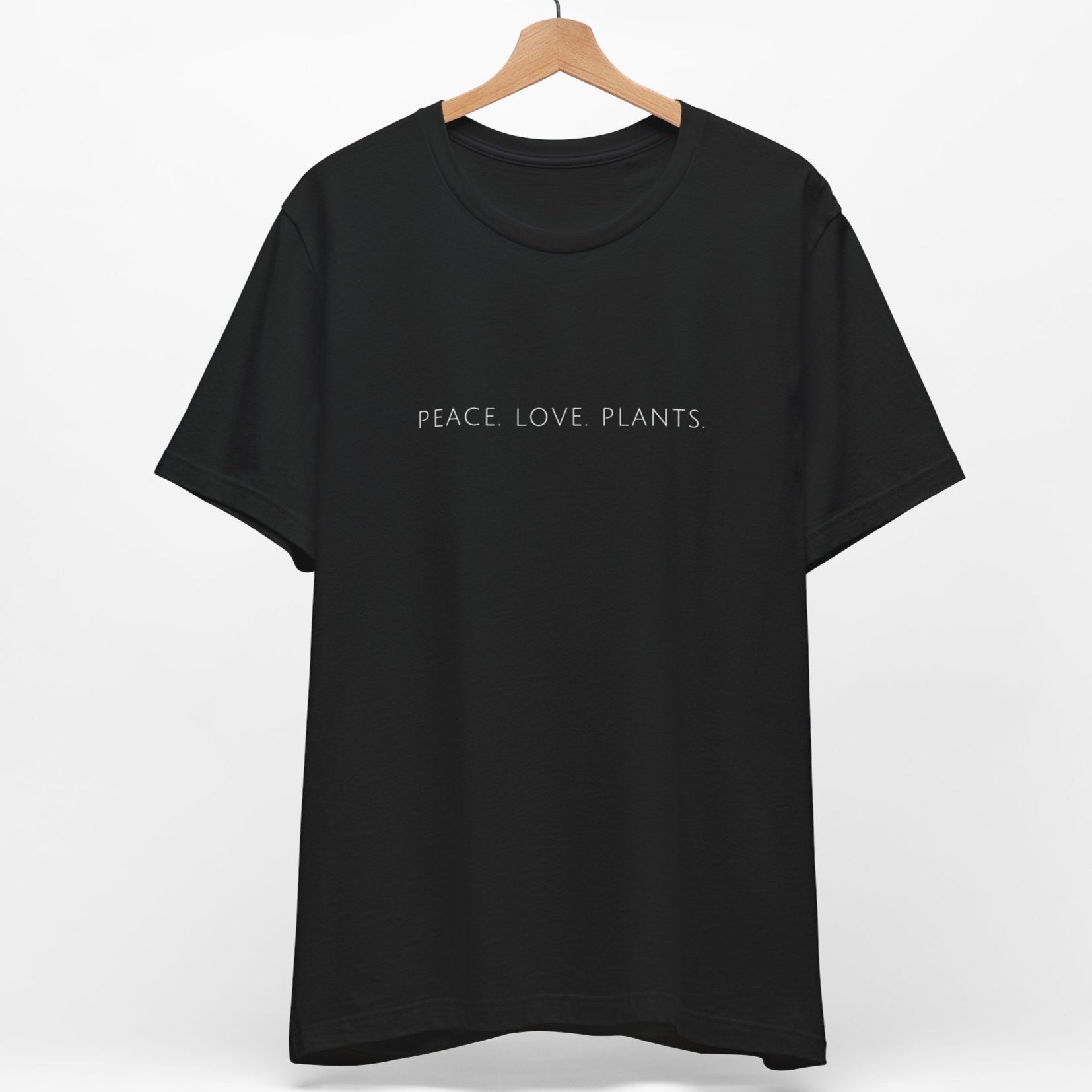 Black vegan t-shirt with the slogan 'peace love plants' written in a minimalist font.