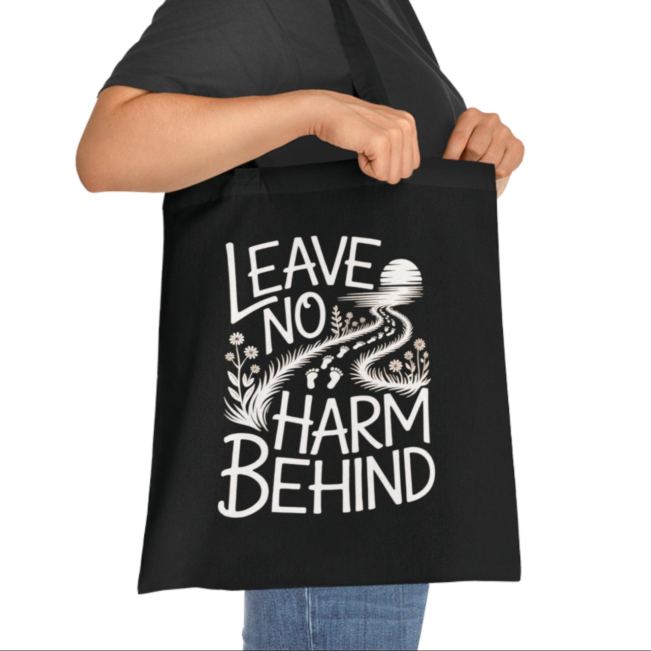 Vegan animal rights tote bag with the slogan 'leave no harm behind' and footprints.