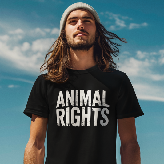 Man wearing a black animal Rights T-Shirt with blue sky in the background.