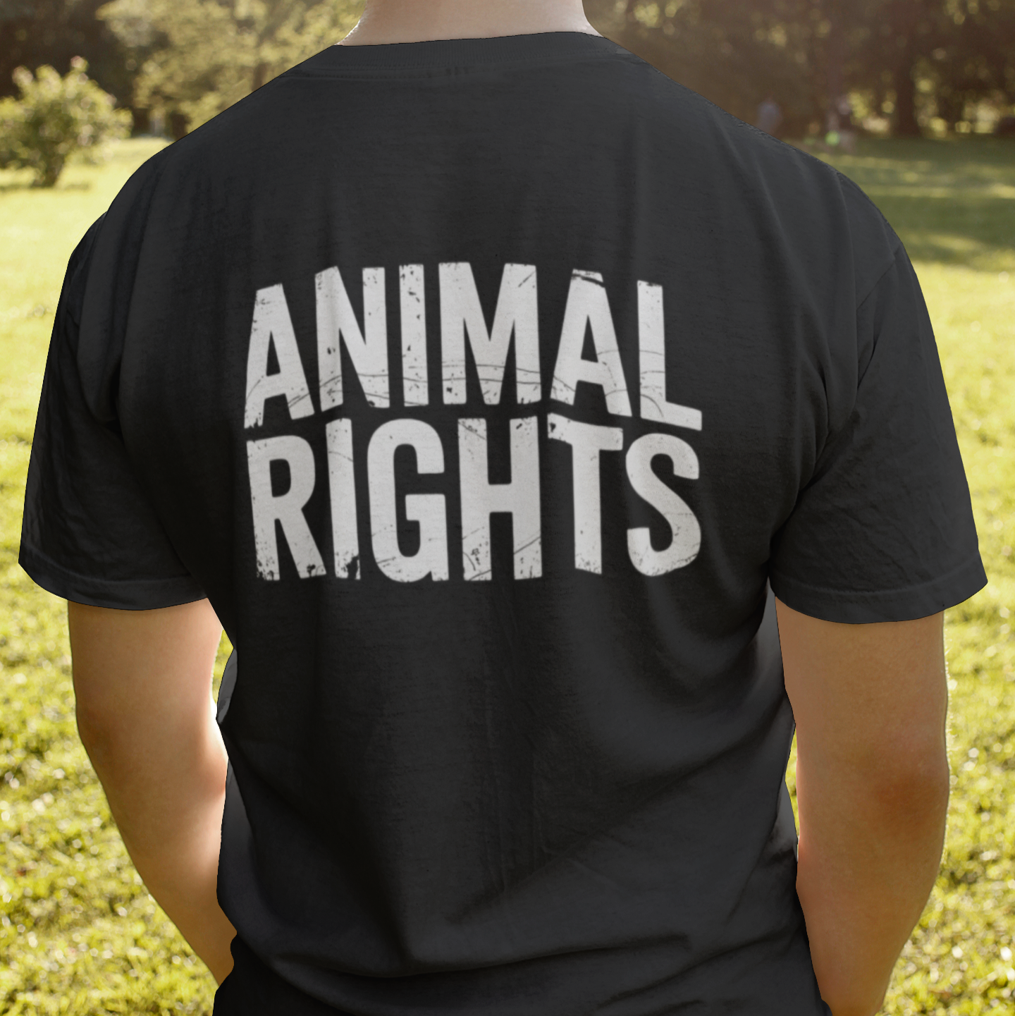Man wearing a black vegan t-shirt with the slogan 'animal rights' printed on the back.