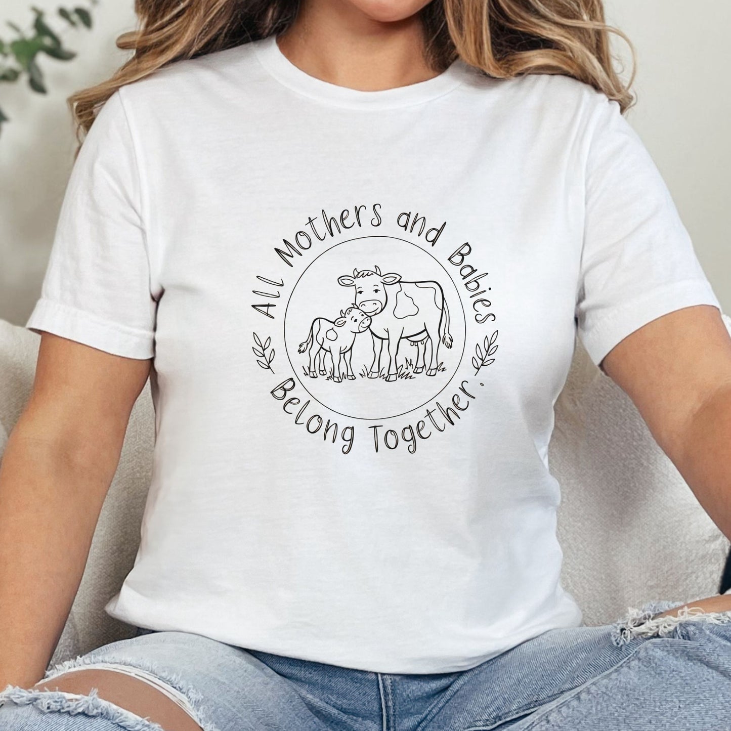 White vegan t shirt with cow design and the anti dairy slogan all mothers and babies belong together.