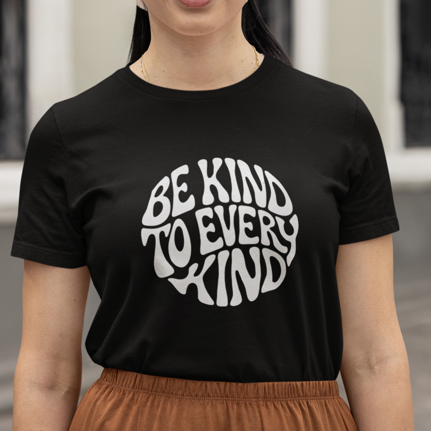 Woman wearing a vegan animal rights t-shirt with the words 'be kind to every kind'.