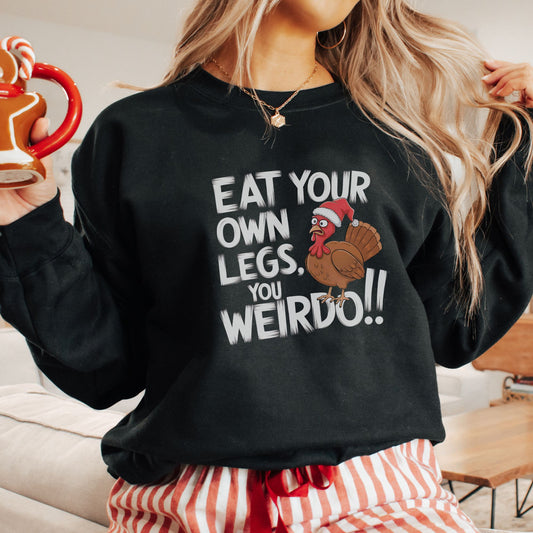 Hilarious vegan Christmas jumper with a picture of a turkey wearing a Christmas hat, and the slogan 'eat your own legs, you weirdo!'
