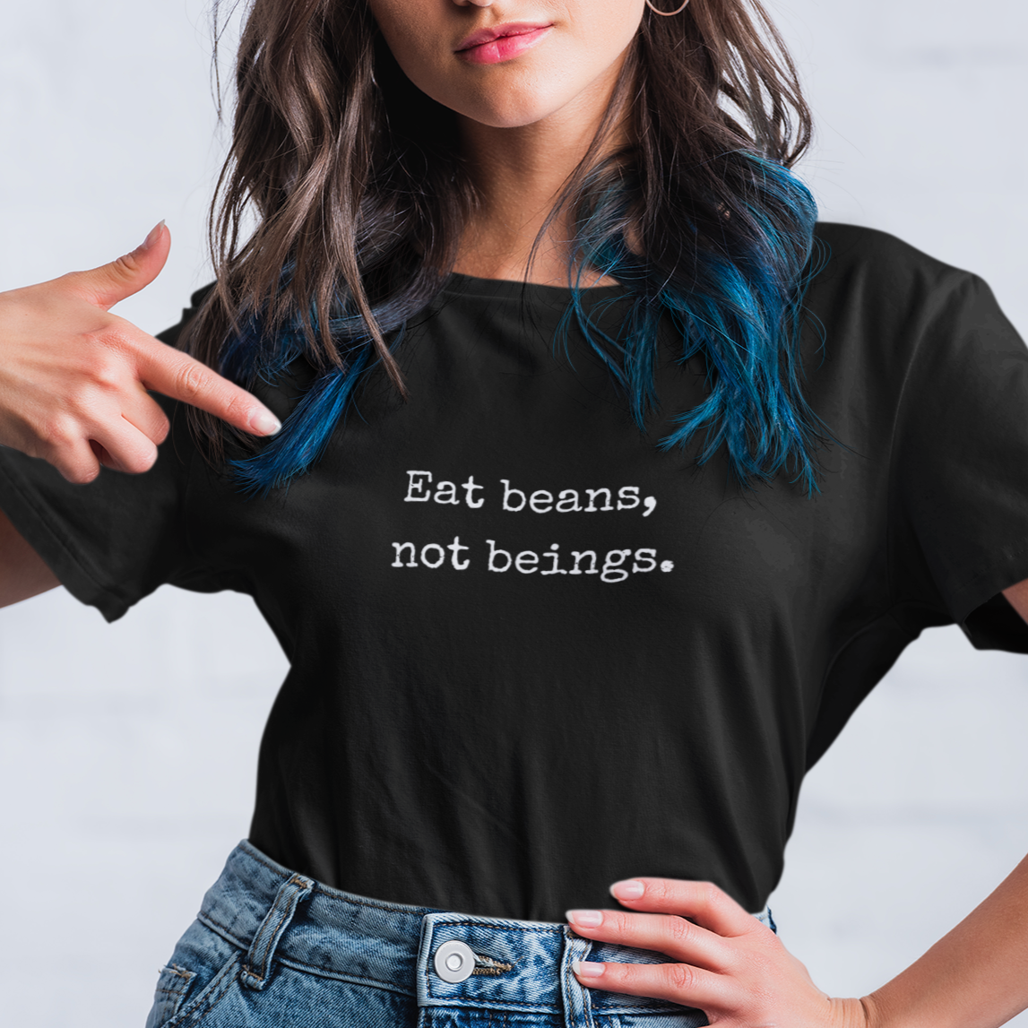 Woman wearing a funny black vegan t shirt with the slogan 'eat beans, not beings'.