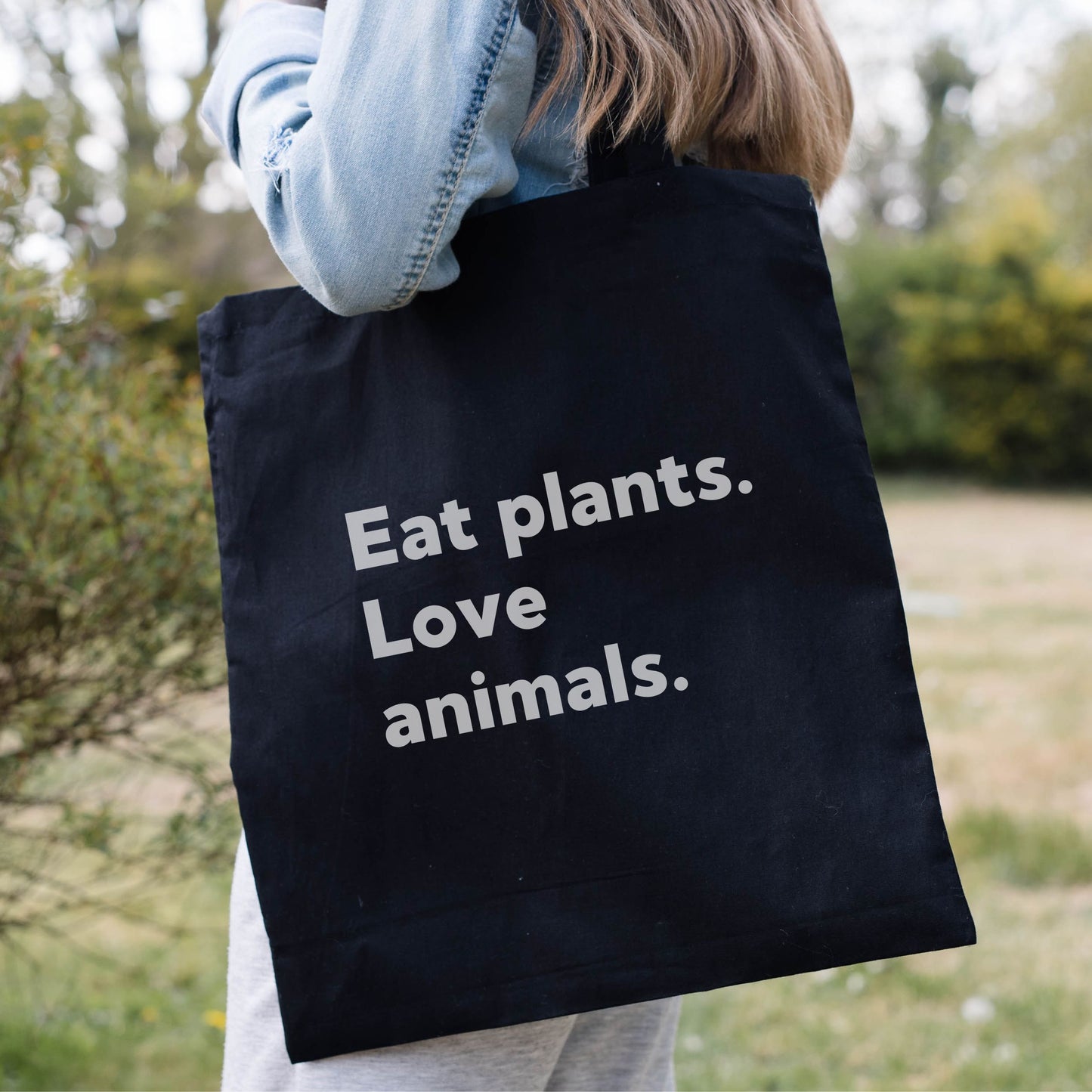 Black tote bag  for vegans or vegetarians with the slogan 'eat plants, love animals'
