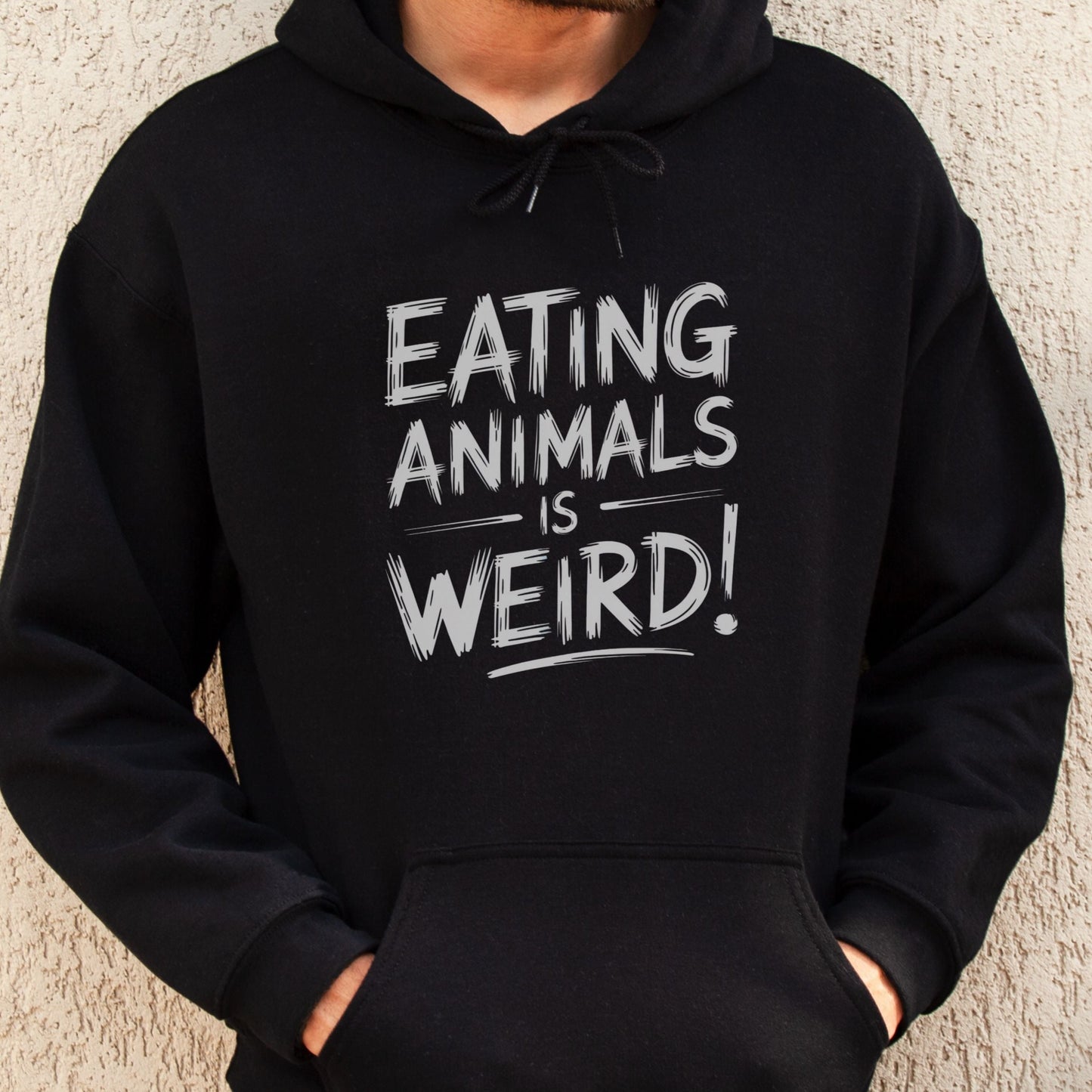 Black vegan or vegetarian sweatshirt with the slogan 'eating animals is weird'