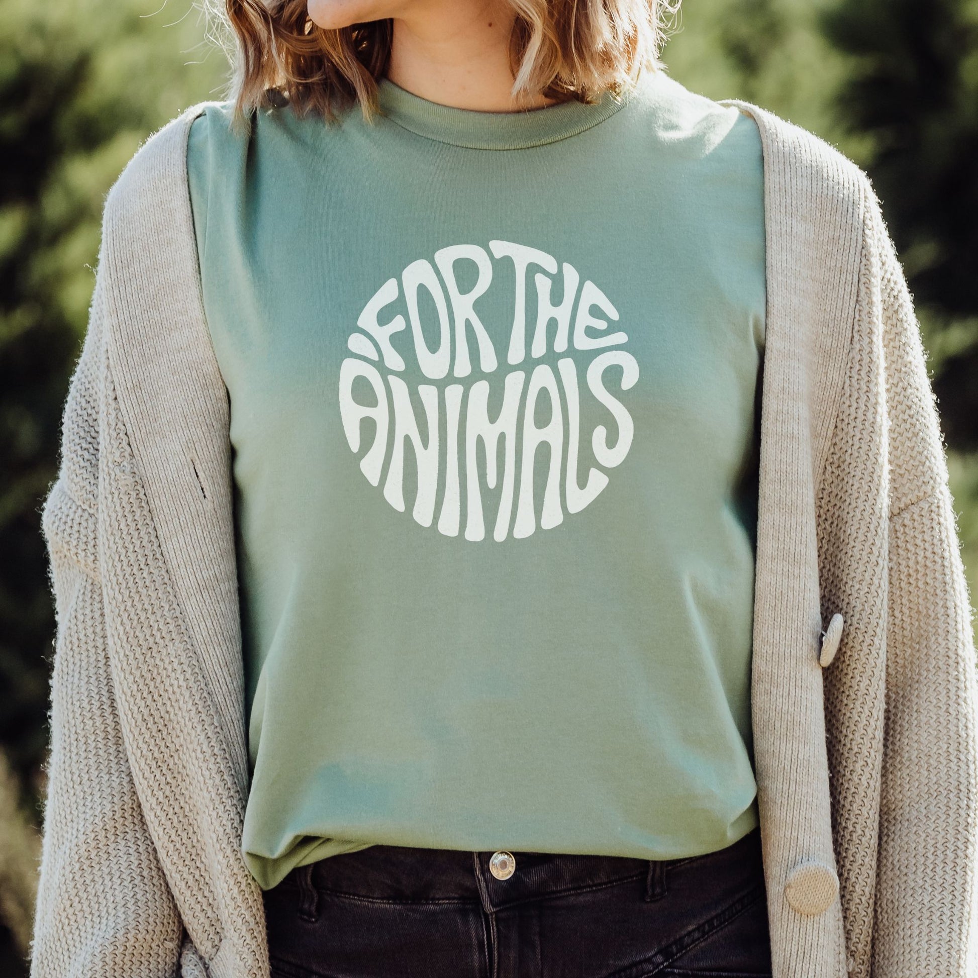 Sage green vegan t-shirt with the slogan For The Animals