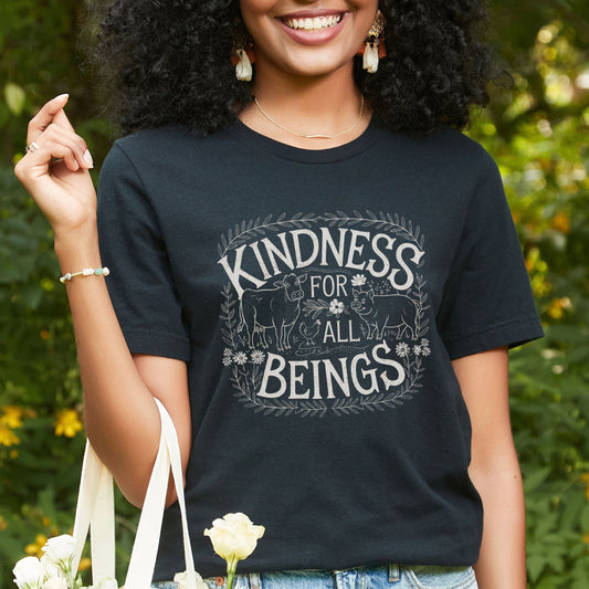 Black vegan tee shirt  featuring the slogan 'Kindness For All Beings' along with a farm animals graphic.