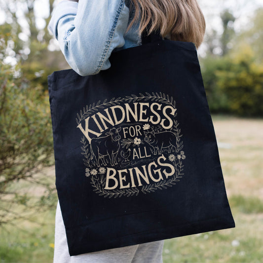 Black tote bag for vegans with the slogan 'Kindness for all beings' and a picture of a cow, pig and chicken.