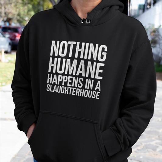 Woman wearing a black animal rights hoodie with the slogan 'nothing humane happens in a slaughterhouse'.
