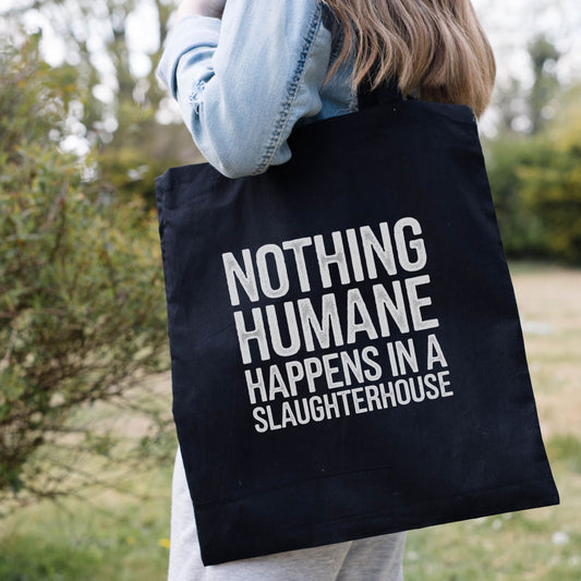 Black vegan tote bag with the slogan 'Nothing humane happens in a slaughterhouse'