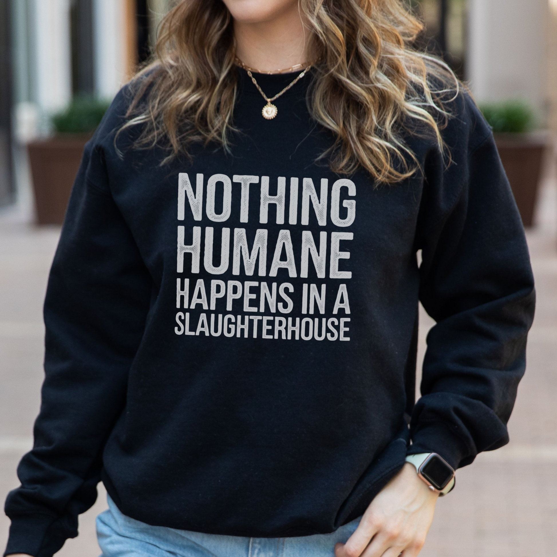 Black animal rights sweatshirt with the slogan 'nothing humane happens in a slaughterhouse'