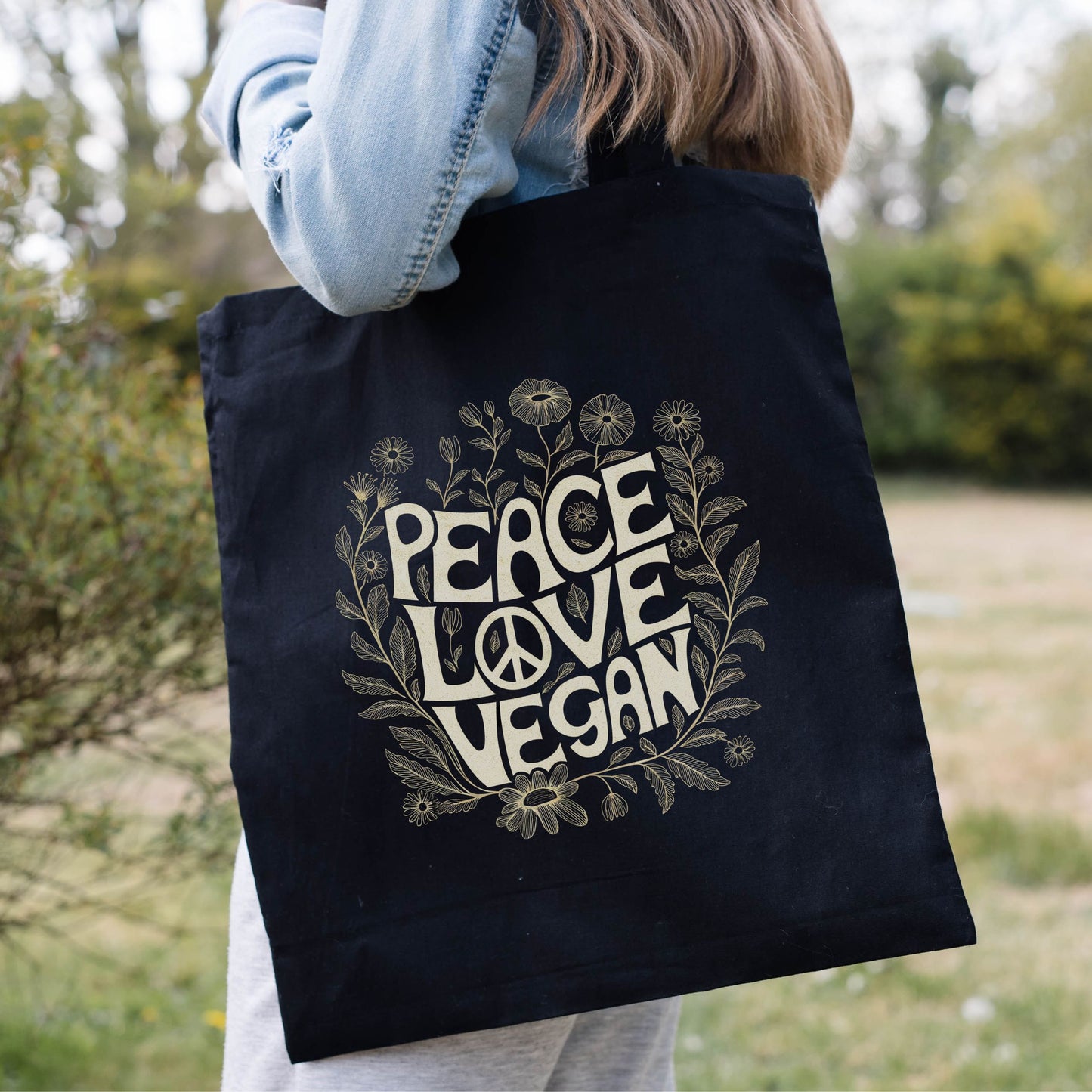 Vegan tote bag with the slogan 'peace, love, vegan' along with a peace sign and flowers.