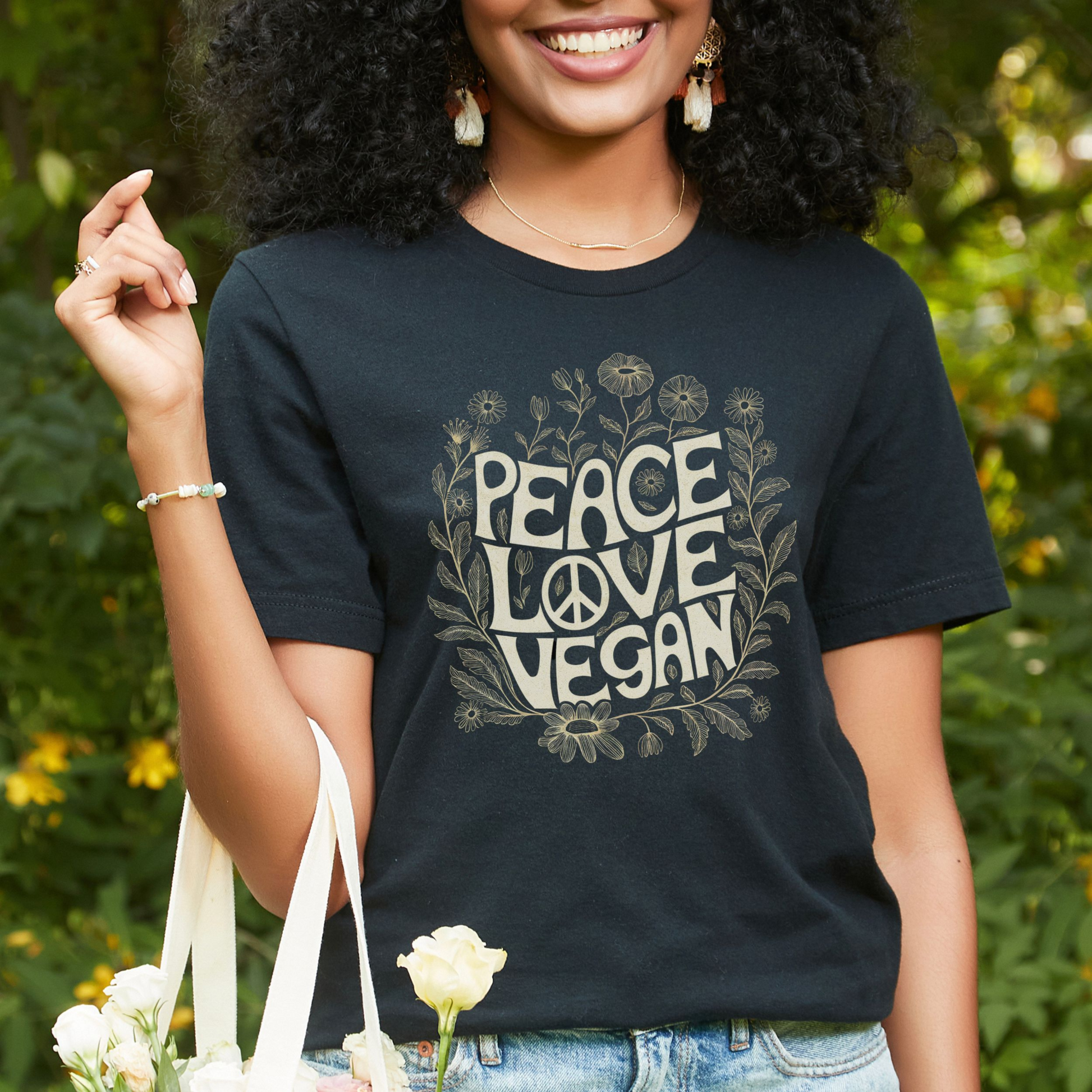 Black t-shirt with the slogan 'Peace Love, Vegan' and flowers.