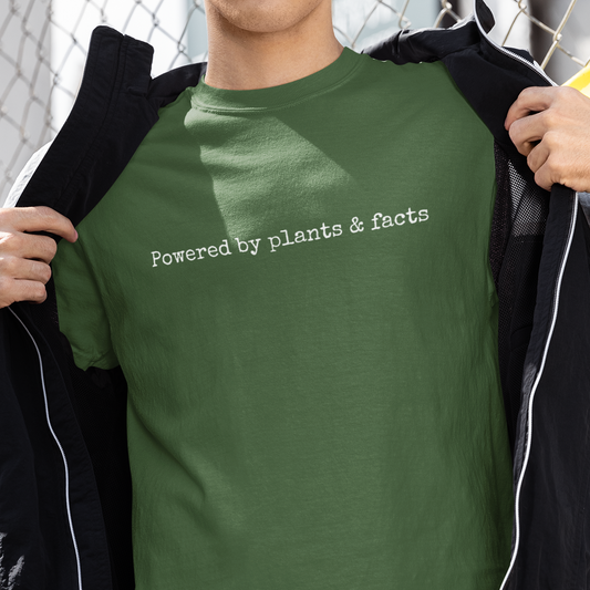 Man wearing a khaki green vegan t shirt with the slogan Powered By Plants & facts