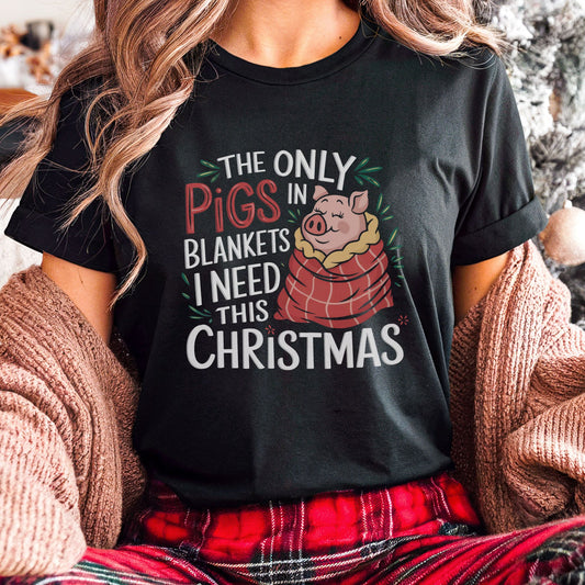 Vegan Christmas t-shirt with a graphic of a cute pig wrapped in a blanket and the slogan 'the only pigs in blankets i need this Christmas'