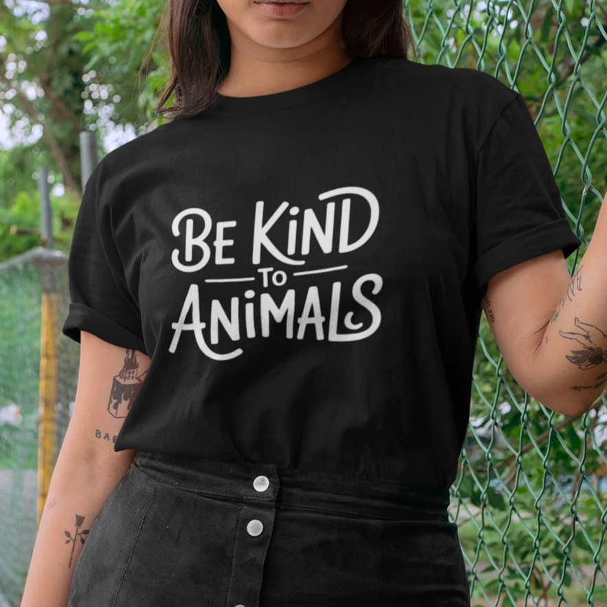 Woman wearing a black t-shirt with the slogan 'be kind to animals' for vegans, animal lovers and animal rights activists.